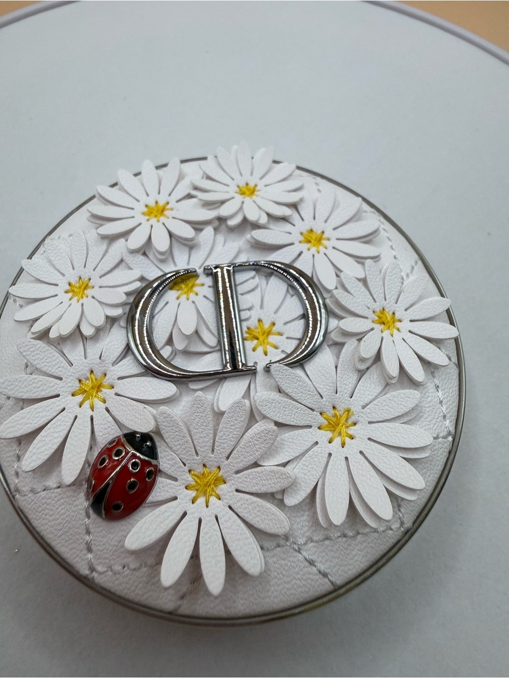 Dior White Floral Daisy Compact with Yellow Centers and Red Ladybug Accent